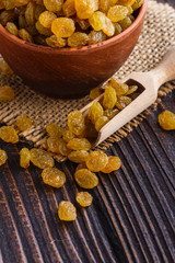 golden raisins on a wooden rustic background