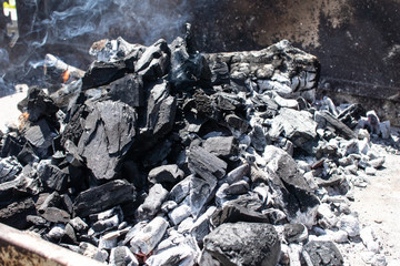 charcoal burning and ready for the barbecue, preparation of the embers to cook meat on the grill. hot steaming charcoal