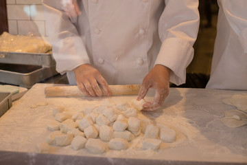 Hands of chefs making dough for grilled rice dumplings in Chinatown in Kobe in Japan