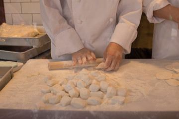 Hands of chefs making dough for grilled rice dumplings in Chinatown in Kobe in Japan