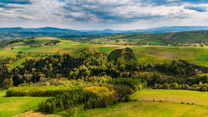 Fototapeta na wymiar Green hills with meadows and forest, aerial view of polish countryside