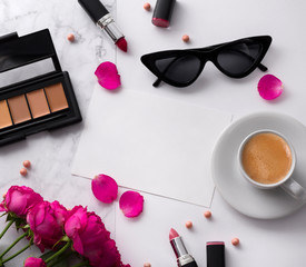 Obraz na płótnie Canvas Bouquet of pink roses, cup of coffee, sunglasses, concealer and lipstick on white table. 