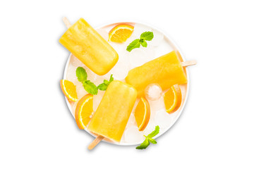 Naklejka na ściany i meble Orange juice homemade popsicles, isolated on white