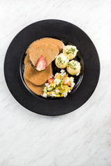 Pork meat with sauce, potatoes and salad, restaurant serving portion