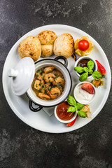 Prawns served on platter with sauces and fresh bread