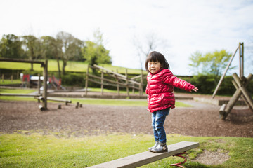 Fototapeta premium toddler girl play at outdoor playground