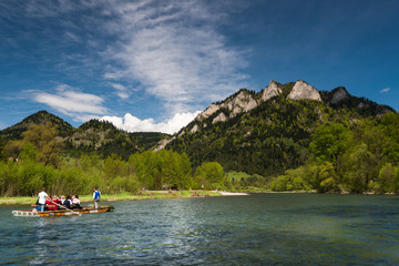Traditional rafting on Dunajec river, Three Crowns mountains peak in background