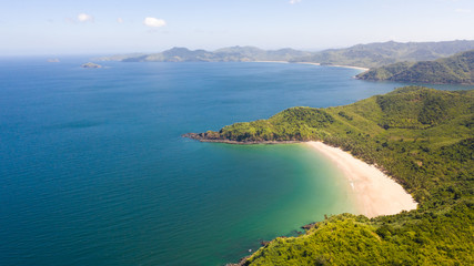 Beautiful island with a lagoon and a white beach. Seascape with islands in clear weather.Philippines El Nido aerial view