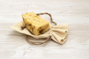 Natural organic bar of handmade soap on a linen bag. cosmetics for home care and spa of natural ingredients
