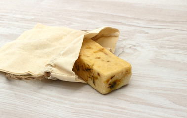 Natural organic bar of handmade soap on a linen bag. cosmetics for home care and spa of natural ingredients