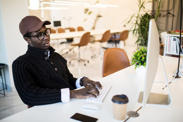 Portrait of african american businessman working on his laptop. Handsome young man at his desk.