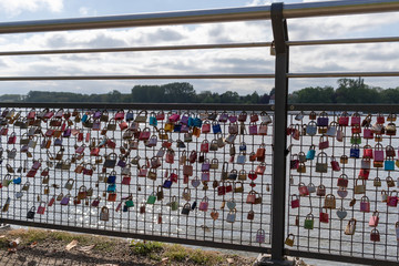 Several colorful padlocks hanging at a fence as a symbol for eternal love
