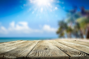 Desk of free space and summer background of beach with palms and summer sea 