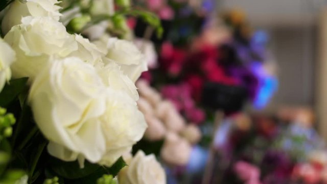 Many beautiful holiday bouquets of different flowers in a flower shop are ready for sale. Price of the bouquet is written on the plate. Romantic surprise on Valentine's day. 