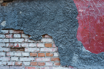 Concrete background. Rough texture. Cracked gray, red paint. Stone brick wall