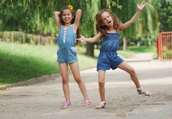 Fototapeta premium photo of two little girls in summer park