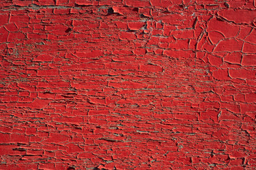 Wooden background. Rough texture. Cracked red paint
