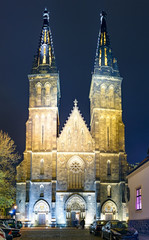 The Basilica of St Peter and St Paul - neo-Gothic church in Vyshegrad fortress in Prague, Czech Republic in night illumination