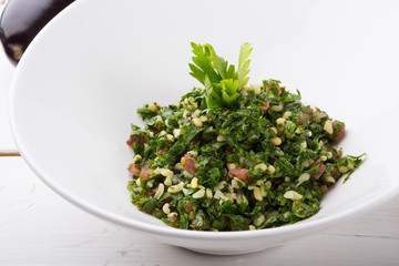 Lebanese tabbouleh appetizer salad served in a white bowl