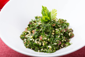 Lebanese tabbouleh appetizer salad served in a white bowl