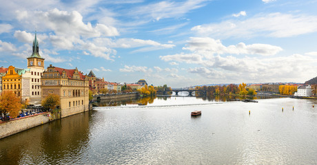 Scenic view of bridges on the Vltava river and of the historical center of Prague, Czech Republic. Buildings and landmarks of old town with red rooftops and multi-colored walls