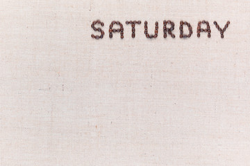 The word Saturday written with coffee beans , aligned at the top right.