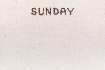 The word Sunday written with coffee beans , aligned at the top.