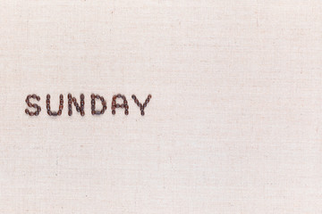 The word Sunday written with coffee beans , aligned to the left.