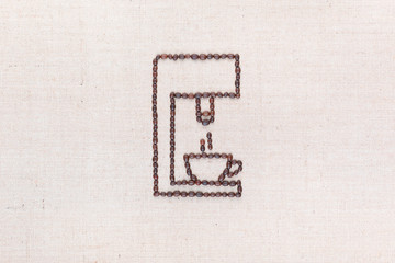 A coffee machine preparing a coffee all made from coffee beans, aligned in the center.