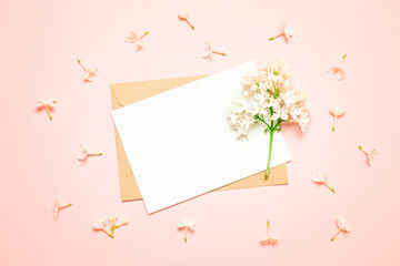 Mockup white greeting card and envelope with lilac branches on a light background
