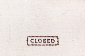 The word Closed inside a rectangle written with coffee beans,aligned at the bottom.