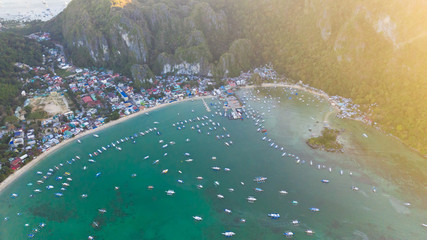 The beautiful bay with boats. Aerial view.Aerial view of sailing boats and yachts in the bay. Boat and yacht in the tropical lagoon. Aerial view: tropical landscape.vPhilippines, El Nido. Travel