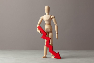 Businessman holds red down arrow chart. Drop in profitability or bankruptcy, decline in income.