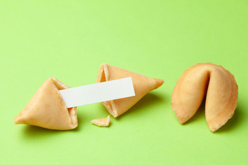 Chinese fortune cookies. Cookies with empty blank inside for prediction words. Green background.