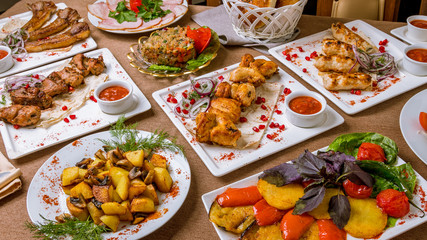 Foodset from chicken kebab, veal kebab, fried potatoes with mushrooms, grilled vegetables, rack of lamb and lula kebab