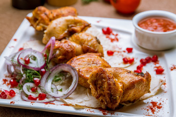 chicken kebab on white plate