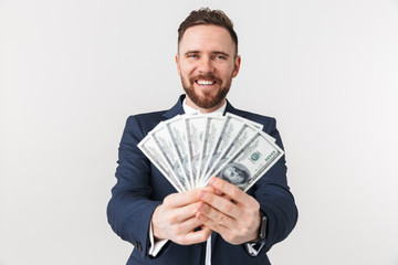 Businessman posing isolated over white wall background with money.