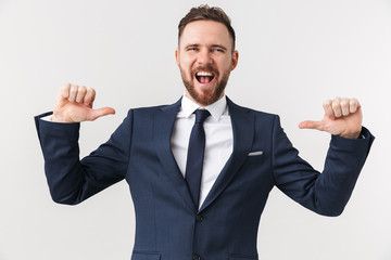 Businessman posing isolated over white wall background pointing to himself.