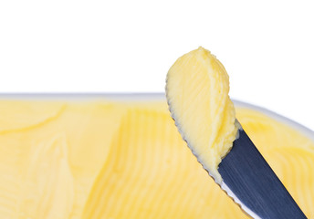 Margarine cheese butter with knife on white background