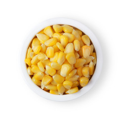 The corn seeds on bowl isolated on white background. Top view.