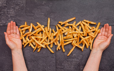 Woman hands on slate table with french fries