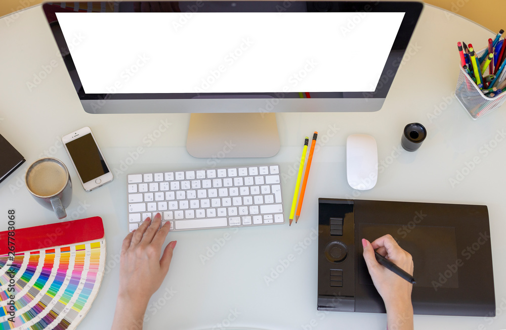 Fototapete designer drawing on digital tablet at workspace top view with essential elements on white table.