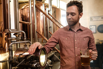 Man tasting fresh beer in a brewery