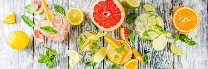 Summer refreshment drinks. Four types of citrus lemonade or mojito cocktail - orange, lime, lemon,...