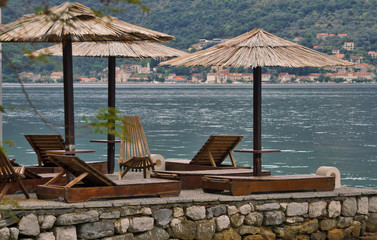 empty sun loungers are on the pier. holiday in Montenegro