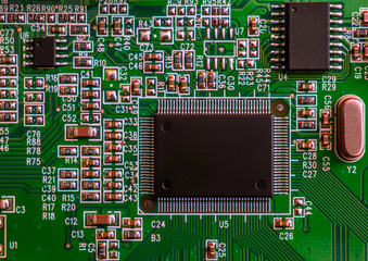Computer circuit board (view from above). Green circuit motherboard card with chip, processor and...