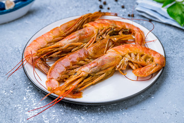 some langoustines on a plate on grey concrete