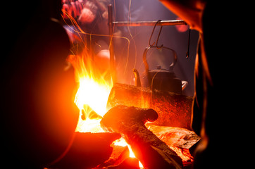 Kettle on the fire at night. Tourism.