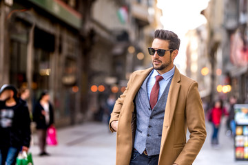 An elegant man walking on the streets - 267787622