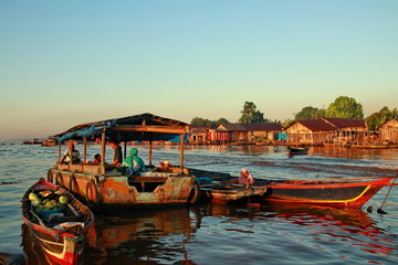 Citra Bahari Barito river floating market in the morning, full of gold from the sunrise in...